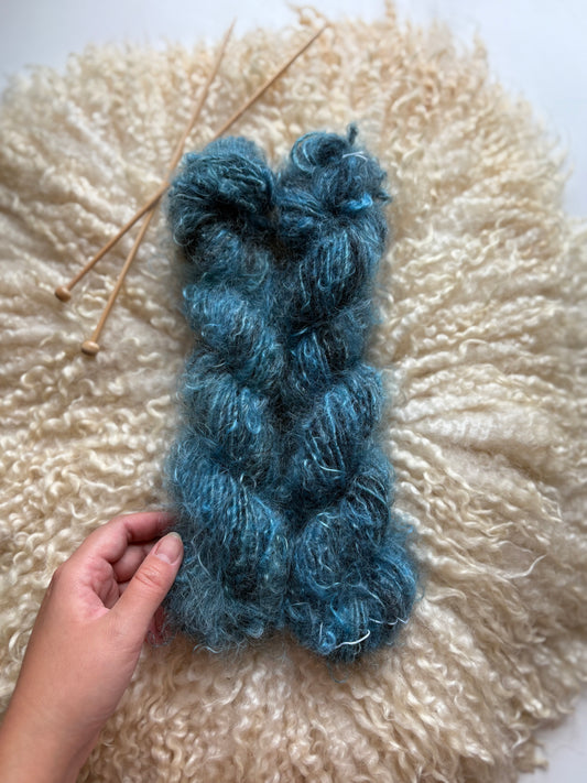 Single ply 100% adult mohair lock spun art yarn. 3.50oz 60 yards dyed from Stormy. Medium Soft.